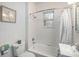 Bright bathroom featuring white tile, bathtub with shower, and modern fixtures at 3019 Meade St, Denver, CO 80211