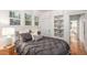 Bedroom with built-in shelves, a comfortable bed, and natural lighting at 3019 Meade St, Denver, CO 80211