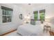 Bedroom with a comfortable bed, natural lighting, neutral decor and views of outdoor landscape at 3019 Meade St, Denver, CO 80211