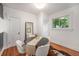 Stylish dining room with hardwood floors, large window and decorative mirror at 3019 Meade St, Denver, CO 80211