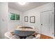 Cozy dining room with modern lighting and a stylish, round table at 3019 Meade St, Denver, CO 80211