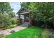 Charming brick home with stone walkway, grassy lawn, and attractive landscaping at 3019 Meade St, Denver, CO 80211