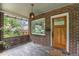 Inviting front porch featuring brick accents, a hanging lantern, and wood door at 3019 Meade St, Denver, CO 80211