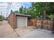 A detached one car garage with a newer concrete driveway and fencing for secured parking and privacy at 3019 Meade St, Denver, CO 80211