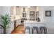Modern kitchen featuring white cabinets, stainless steel appliances, breakfast bar with seating, and an open layout at 3019 Meade St, Denver, CO 80211