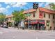 Corner street view of commercial buildings with outdoor dining, local retail, and lively street activity at an intersection at 3019 Meade St, Denver, CO 80211