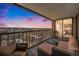 Spacious balcony featuring outdoor seating and grill, offering stunning city views and vibrant sunset colors at 1551 Larimer St # 2602, Denver, CO 80202