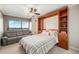 Cozy bedroom featuring a Murphy bed, shelving and a comfortable couch with city views at 1551 Larimer St # 2602, Denver, CO 80202
