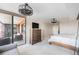 Bright main bedroom featuring a ceiling fan, hardwood floors, and access to a private balcony at 1551 Larimer St # 2602, Denver, CO 80202