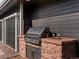 Custom stone-clad outdoor BBQ kitchen with stainless steel grill and counter space, perfect for outdoor cooking and entertaining at 3339 Lowell Blvd, Denver, CO 80211
