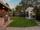 Spacious backyard featuring an outdoor kitchen with built-in grill and a pergola covered seating area at 3339 Lowell Blvd, Denver, CO 80211