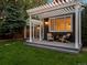 Outdoor living space featuring a pergola covered seating area and a lush green lawn at 3339 Lowell Blvd, Denver, CO 80211