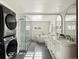 Modern bathroom featuring double vanities, a glass shower, and a soaking tub for a spa-like experience at 3339 Lowell Blvd, Denver, CO 80211