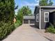 Long driveway leading to the three-car garage of the home, bordered by mature trees and lush landscaping at 3339 Lowell Blvd, Denver, CO 80211