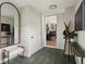 Stylish entryway with a large mirror, coat rack, bench, and views into the dining room, creating a sophisticated welcome at 3339 Lowell Blvd, Denver, CO 80211