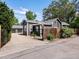 Back exterior showcasing a dark home with a three-car garage, fenced yard, and landscaped details for a private oasis at 3339 Lowell Blvd, Denver, CO 80211