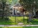 Charming home with a well-manicured front yard, complete with rock path and a classic black fence at 3339 Lowell Blvd, Denver, CO 80211