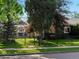 Charming home with a well-manicured front yard, dark painted siding, and a classic black fence at 3339 Lowell Blvd, Denver, CO 80211