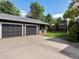 Three car garage featuring a built-in BBQ, a concrete driveway, and a beautiful view of the home at 3339 Lowell Blvd, Denver, CO 80211
