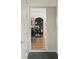 Hallway view leading to the dining room with hardwood floors and an elegant black display cabinet, adding charm at 3339 Lowell Blvd, Denver, CO 80211