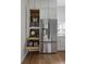 White kitchen with stainless steel refrigerator and floor to ceiling pantry cabinet at 3339 Lowell Blvd, Denver, CO 80211