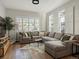 Bright living room with large sectional, wood floors, and plenty of natural light from multiple windows at 3339 Lowell Blvd, Denver, CO 80211