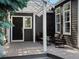 Covered porch with outdoor seating and a black front door at 3339 Lowell Blvd, Denver, CO 80211
