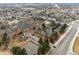 Aerial view of residential area showcasing condo community, tennis courts, and nearby city streets at 3009 Madison Ave # K317, Boulder, CO 80303