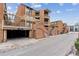 Brick exterior view of community featuring stairs to upper units and covered parking, reflecting classic charm at 3009 Madison Ave # K317, Boulder, CO 80303