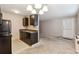 Kitchen featuring dark cabinetry, granite countertops, and view into carpeted living area at 3009 Madison Ave # K317, Boulder, CO 80303