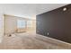 Bright living room with neutral carpet, two windows and a modern accent wall at 3009 Madison Ave # K317, Boulder, CO 80303