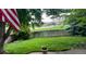View of the backyard with grass, trees, fence, and ball field behind the fence at 10386 Ravenswood Way, Highlands Ranch, CO 80130