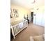 Bright Bedroom featuring a crib, storage and woodland creature art at 10386 Ravenswood Way, Highlands Ranch, CO 80130