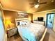 Cozy primary bedroom with a ceiling fan, picture window, and a view into the Bedroom at 10386 Ravenswood Way, Highlands Ranch, CO 80130
