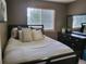 Bedroom with bed, pillows, window, and a dresser with a mirror at 10386 Ravenswood Way, Highlands Ranch, CO 80130