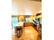 Spacious kitchen with stainless steel appliances, wood cabinets, hardwood floors, and a convenient breakfast bar at 10386 Ravenswood Way, Highlands Ranch, CO 80130