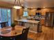 Modern kitchen with stainless steel appliances, light countertops, and an adjoining breakfast nook at 10386 Ravenswood Way, Highlands Ranch, CO 80130