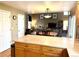 Open layout showing the kitchen featuring granite countertops and connecting to the adjacent dining and living areas at 10386 Ravenswood Way, Highlands Ranch, CO 80130