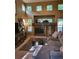 Bright living room features a fireplace, high ceilings, and large windows offering ample natural light at 10386 Ravenswood Way, Highlands Ranch, CO 80130