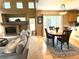 Open layout showcasing the living room with a fireplace, next to the dining area, illuminated by natural light at 10386 Ravenswood Way, Highlands Ranch, CO 80130