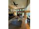 Open living room with a fireplace, complemented by soaring ceilings, a ceiling fan and a view of the backyard at 10386 Ravenswood Way, Highlands Ranch, CO 80130