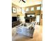 Spacious living room featuring a cozy fireplace, complemented by soaring ceilings and an abundance of natural light at 10386 Ravenswood Way, Highlands Ranch, CO 80130