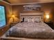 Serene main bedroom with large bed, mountain view artwork, and soft, ambient lighting at 10386 Ravenswood Way, Highlands Ranch, CO 80130