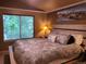 Cozy main bedroom bathed in warm light offering a comfortable retreat with a scenic outdoor view at 10386 Ravenswood Way, Highlands Ranch, CO 80130