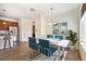 Dining area shows stylish chandelier, marble top table, and access to kitchen at 5755 S Buchanan Ct # E, Aurora, CO 80016