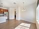 Open dining area with wood floors, modern lighting, and a convenient connection to the kitchen at 5755 S Buchanan Ct # E, Aurora, CO 80016