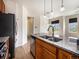 Kitchen shows island with stainless steel sink, and stainless steel appliances at 5755 S Buchanan Ct # E, Aurora, CO 80016