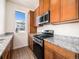 Well-equipped kitchen featuring stainless steel appliances and granite countertops at 5755 S Buchanan Ct # E, Aurora, CO 80016