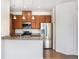 Modern kitchen featuring stainless steel appliances, granite countertops, and warm wood cabinetry at 5755 S Buchanan Ct # E, Aurora, CO 80016