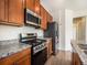 Well-equipped kitchen features stainless steel appliances and granite countertops at 5755 S Buchanan Ct # E, Aurora, CO 80016